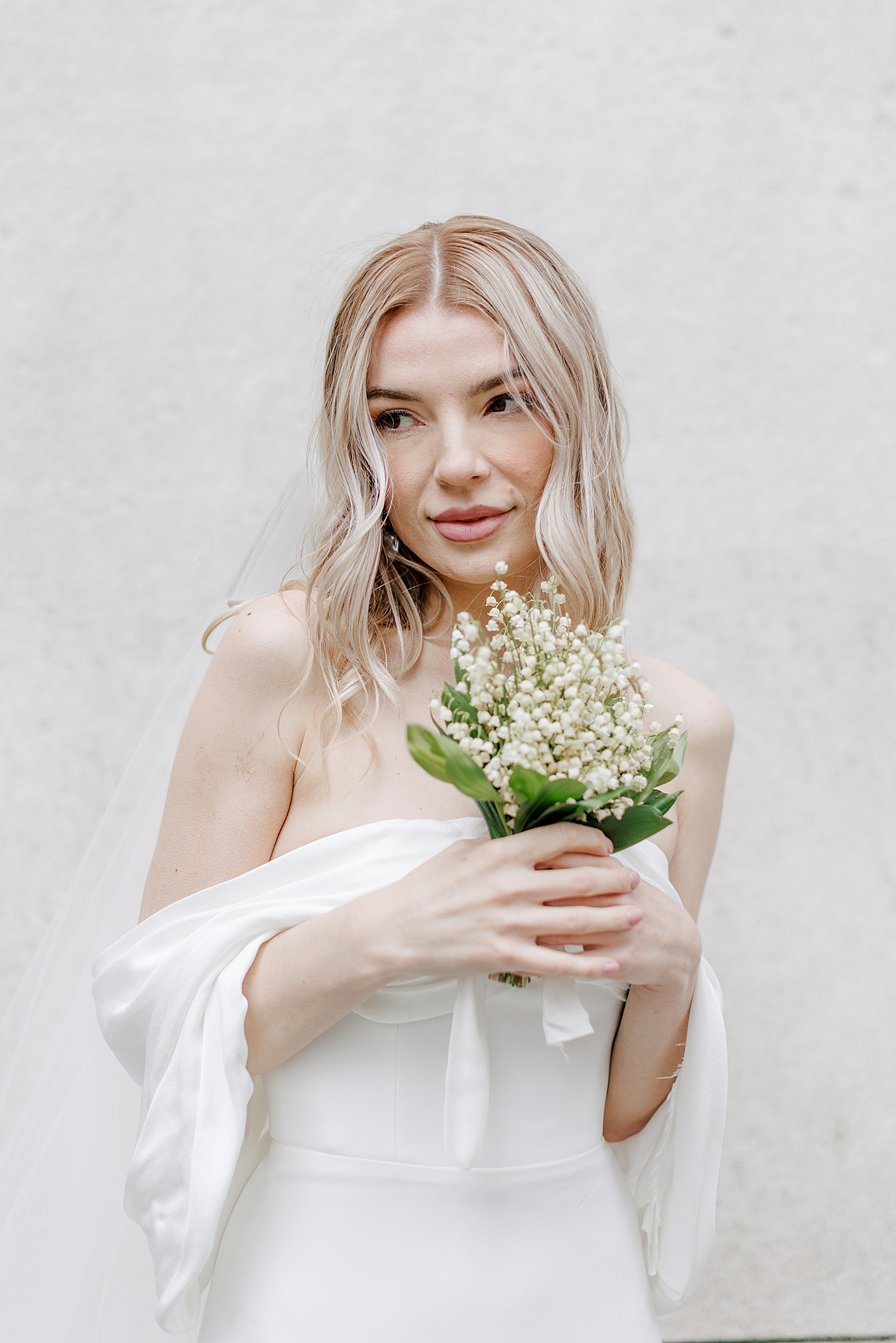 Bride holding a bouquet of Lily of the Valley | Photo by NYC Wedding Photographer Hope Helmuth