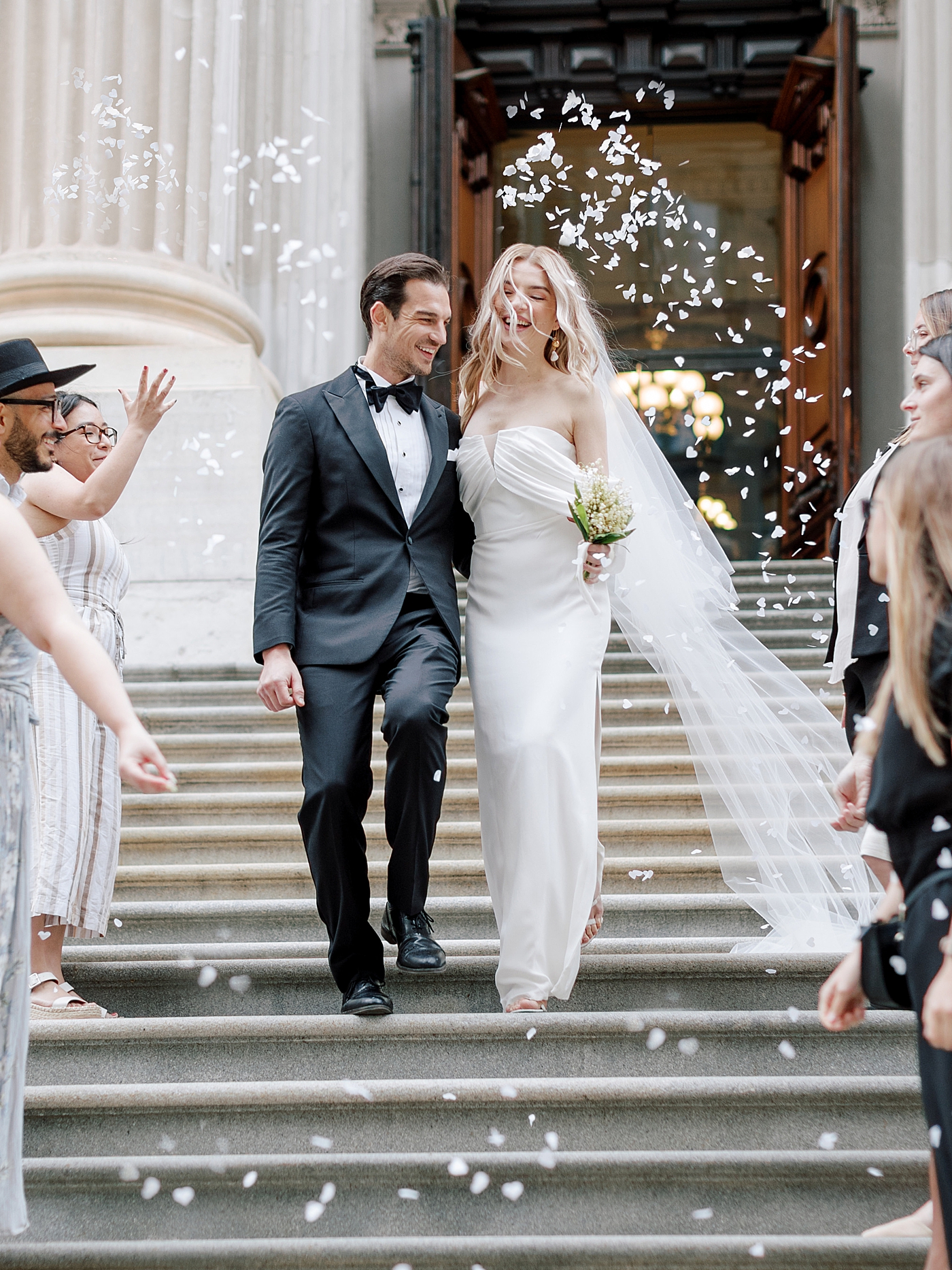 Bride and groom exiting their wedding through confetti | Photo by NYC Wedding Photographer Hope Helmuth 