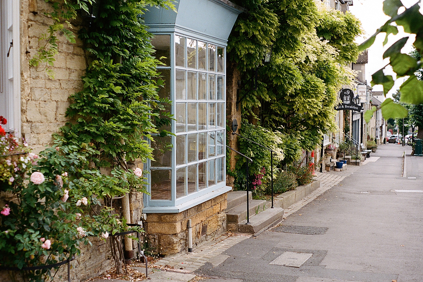 Cute blue window of a storefront in the Cotswolds | Photo by Hope Helmuth Photography