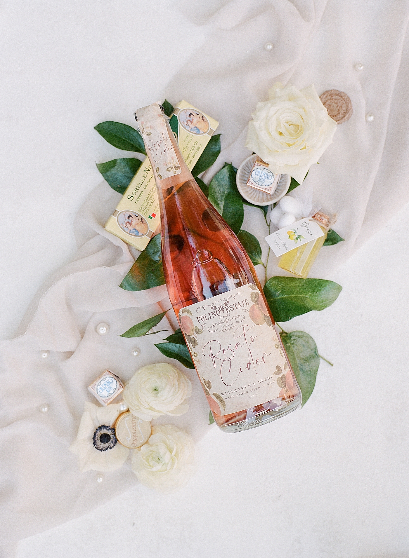 Bottle of rose with bridal details and flowers | Photo by Hope Helmuth Photography
