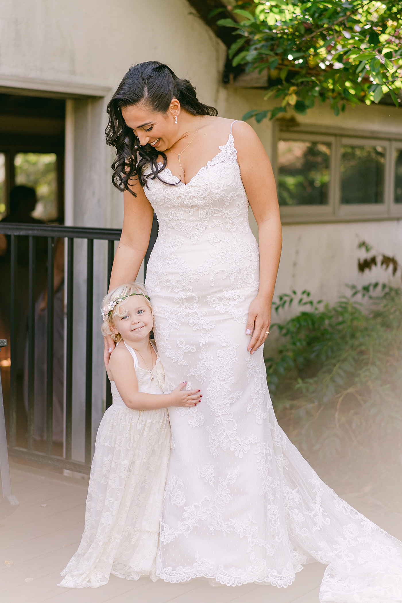 Bride standing with her flower girl | Photo by Hope Helmuth Photography