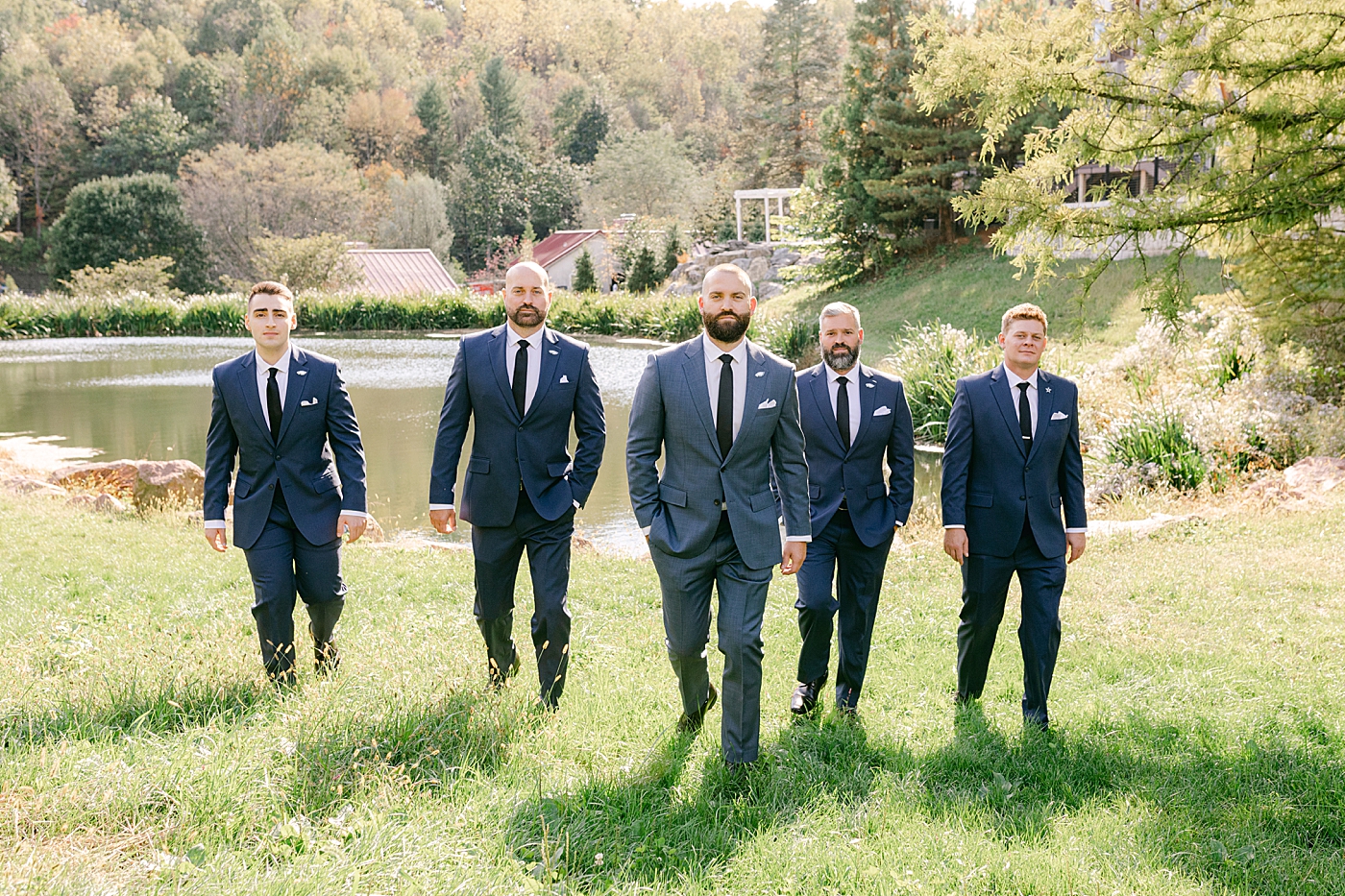 Groomsmen walking in tuxes | Photo by Hope Helmuth Photography
