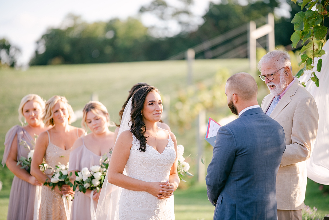 Bride smiling at her groom during their vows | Photo by Hope Helmuth Photography