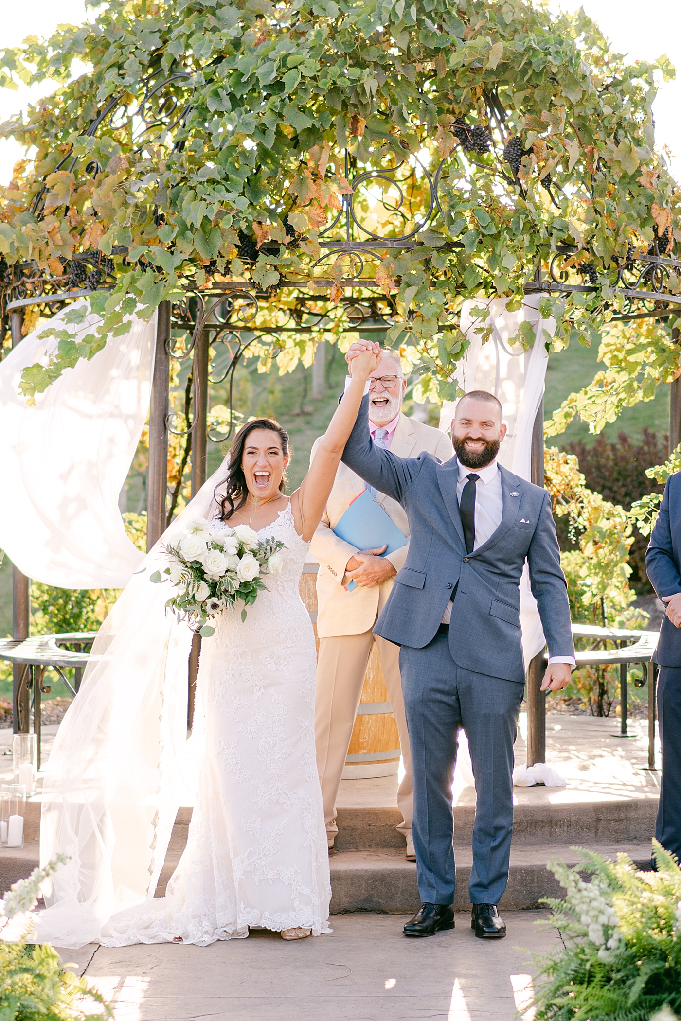 Bride and groom cheering after their vows at folino estate | Photo by Hope Helmuth Photography