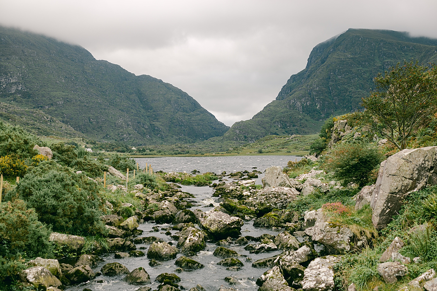 A river with rocks and mountains in the fog | Photo by Destination Wedding Photographer Hope Helmuth