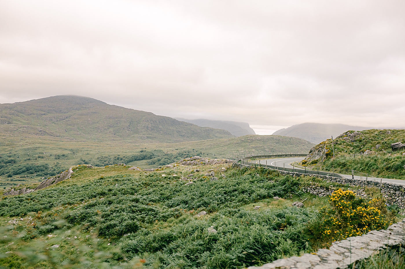 Winding road on the coast of Ireland | Photo by Destination Wedding Photographer Hope Helmuth