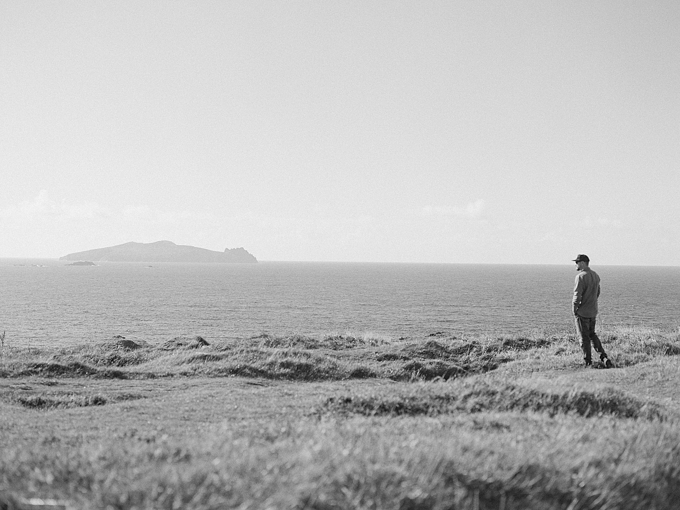 Man walking near the coast in Ireland | Photo by Destination Wedding Photographer Hope Helmuth