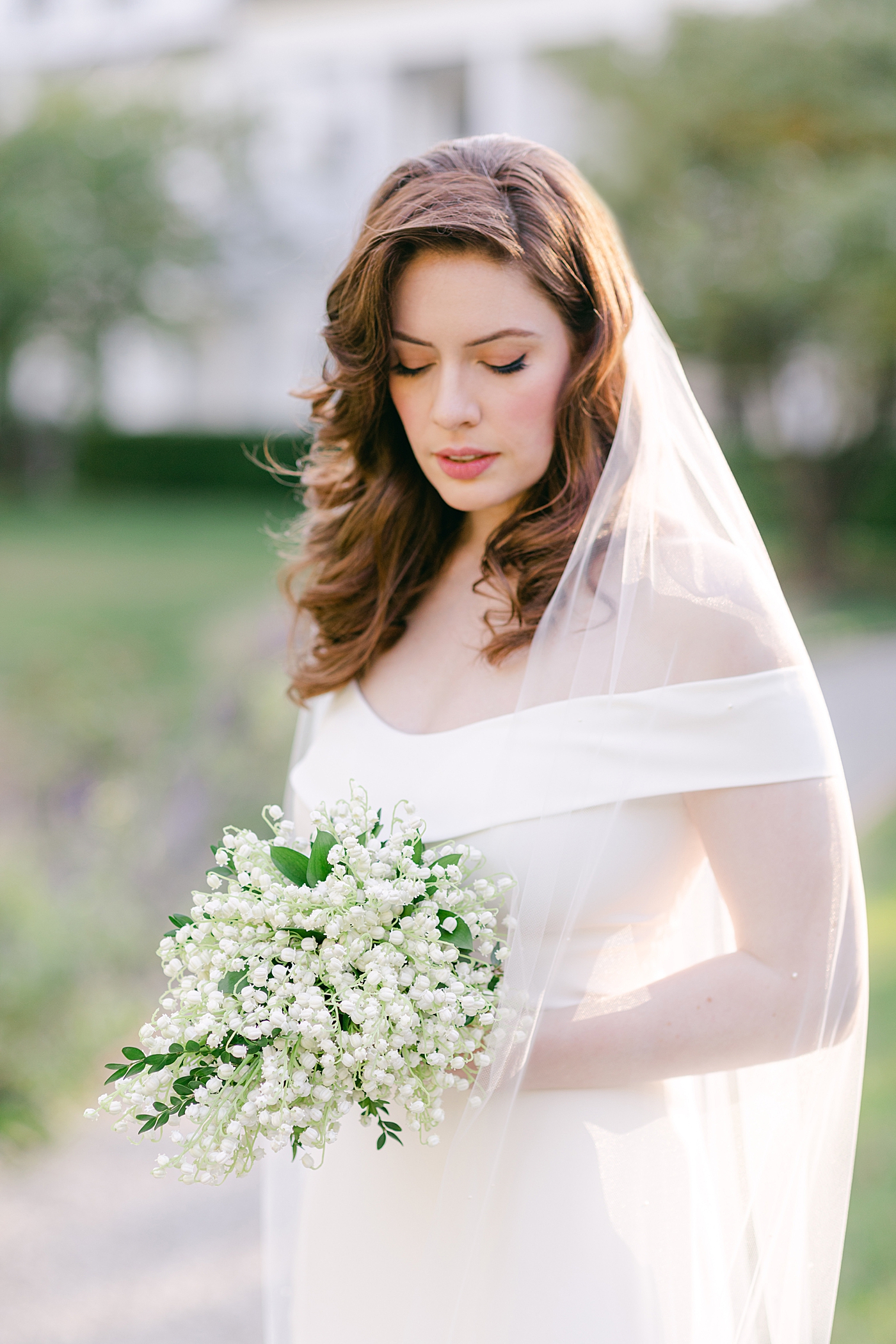 Bride holding a bouquet of lily of the valley | Photo by Hope Helmuth Photography