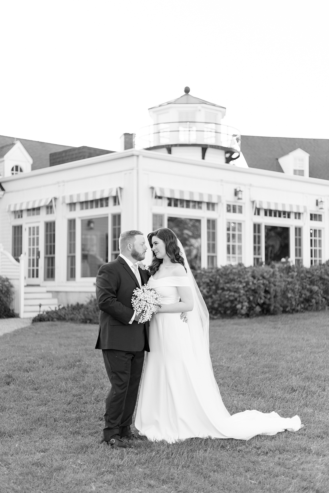 Black and white image of bride and groom on a lawn | Photo by Hope Helmuth Photography