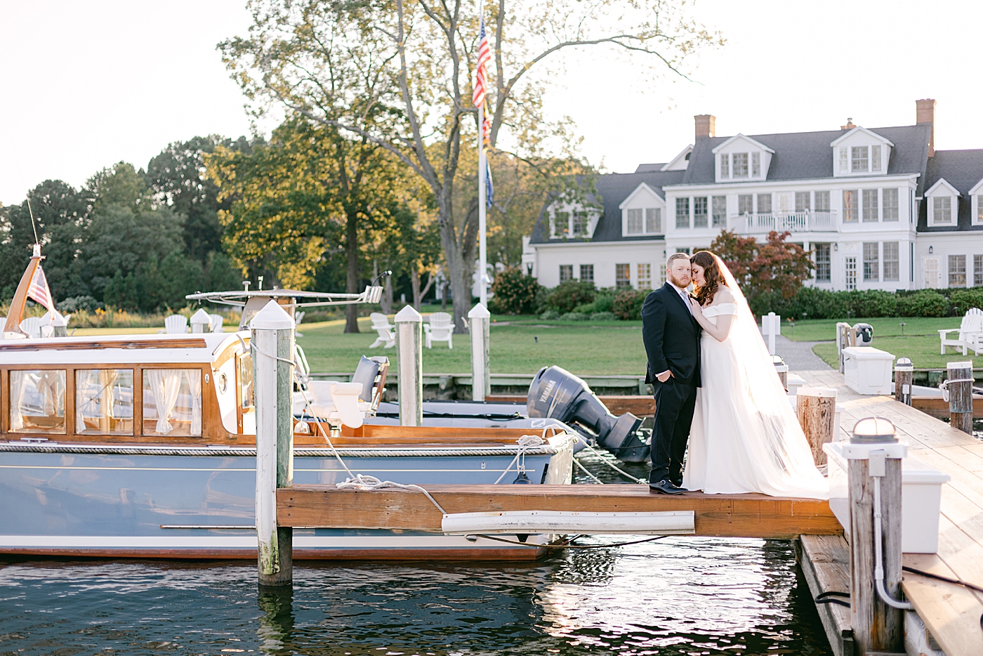 Bride and groom standing together on a dock | Photo by Hope Helmuth Photography