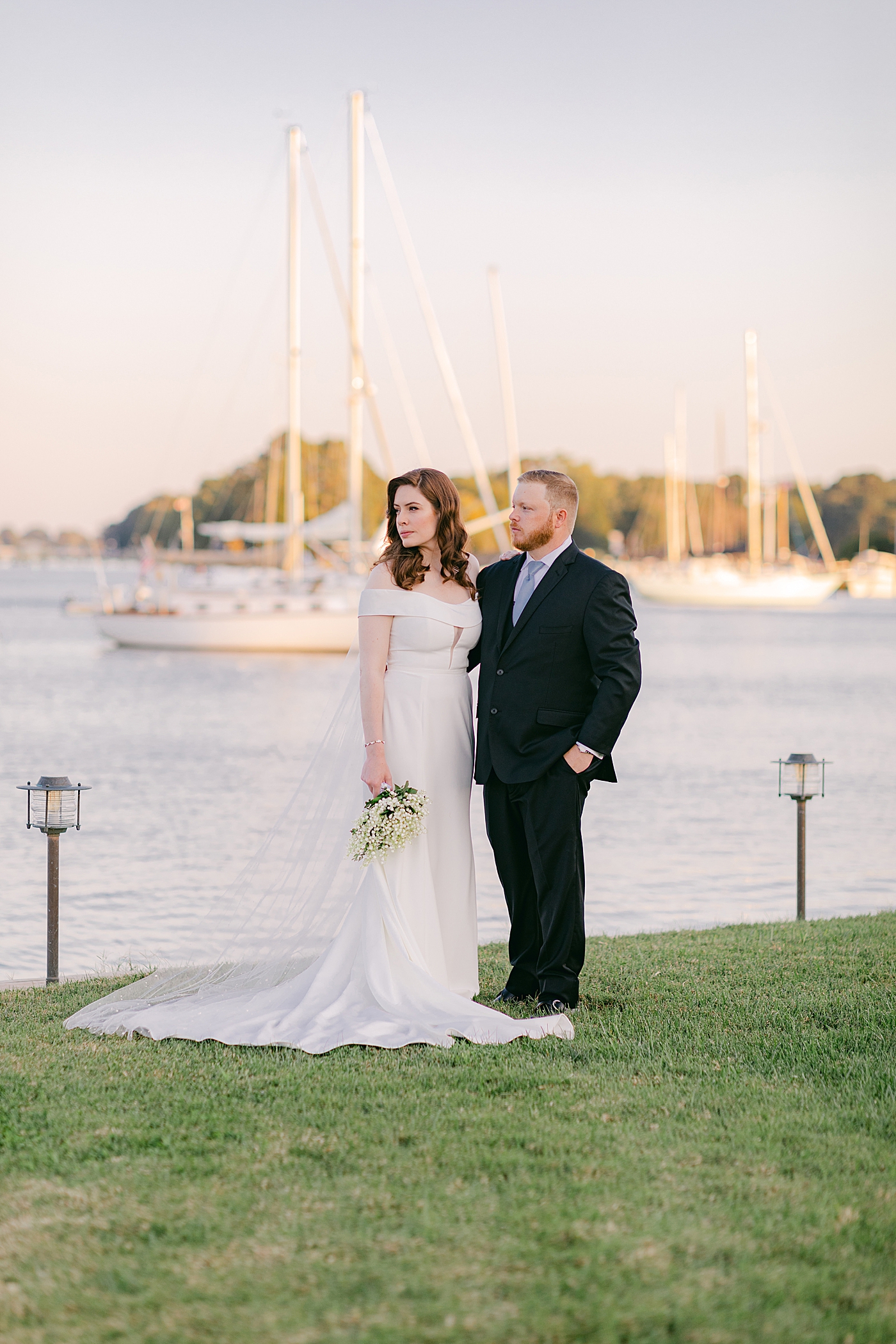 Bride and groom standing together near the harbor | Photo by Hope Helmuth Photography