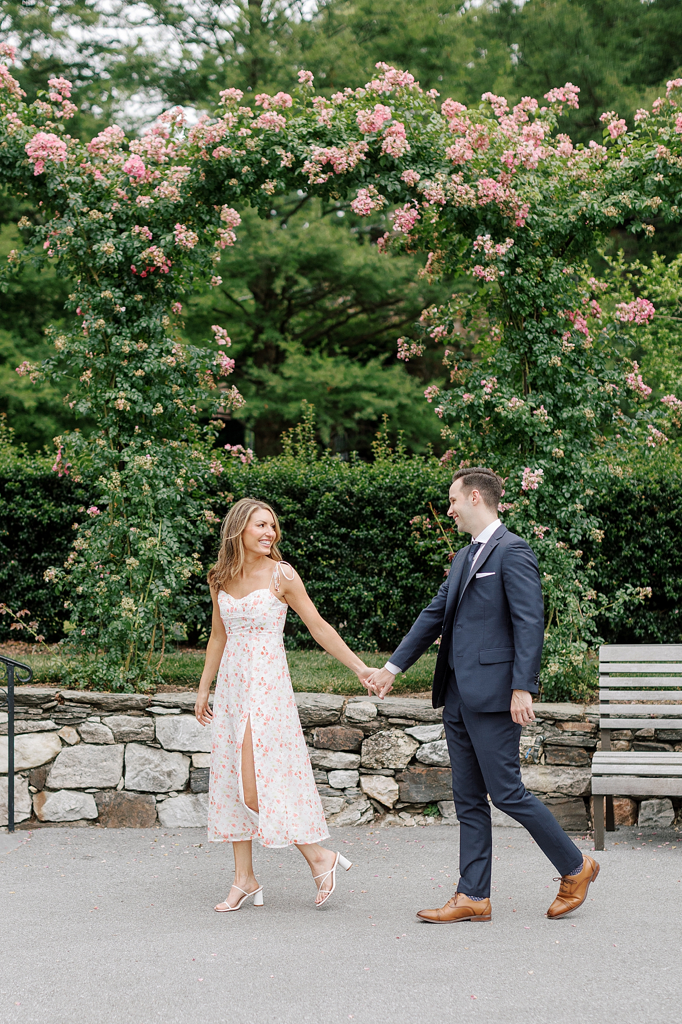 Couple laughing together while holding hands | Photo by Hope Helmuth Photography