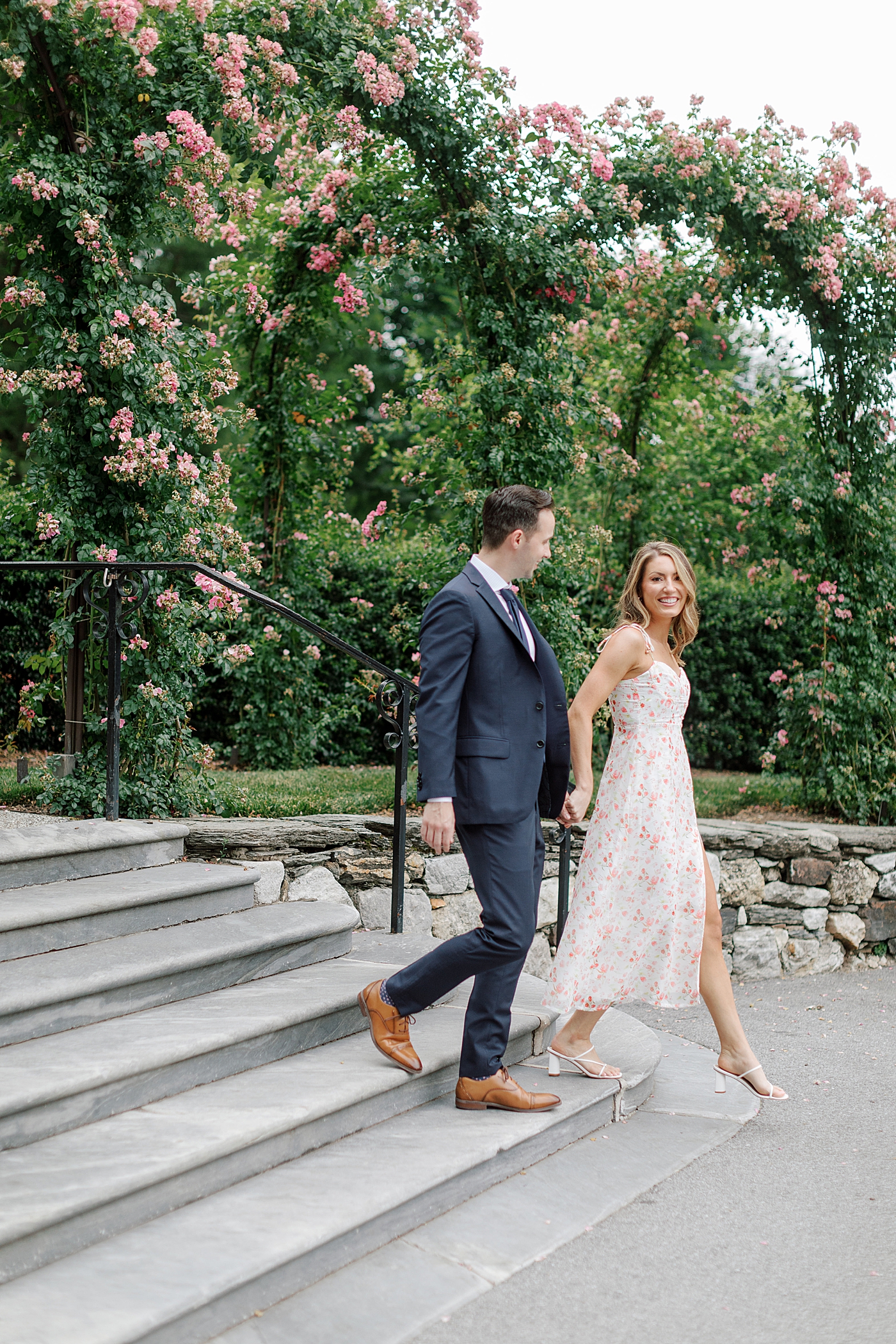 Couple smiling while walking down stairs | Photo by Hope Helmuth Photography