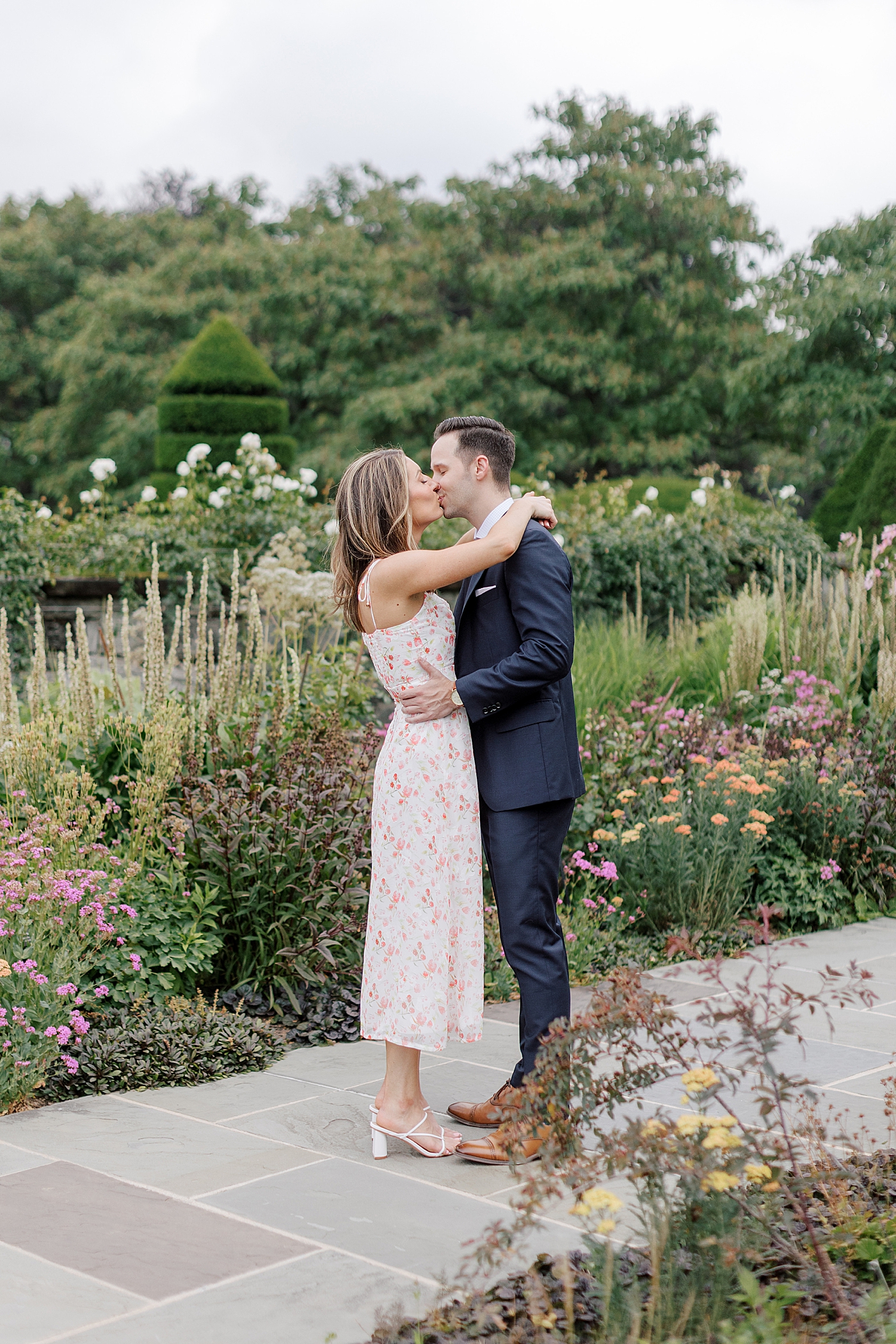 Couple in formal attire kissing in a park | Engagement Session Guides by Hope Helmuth Photography