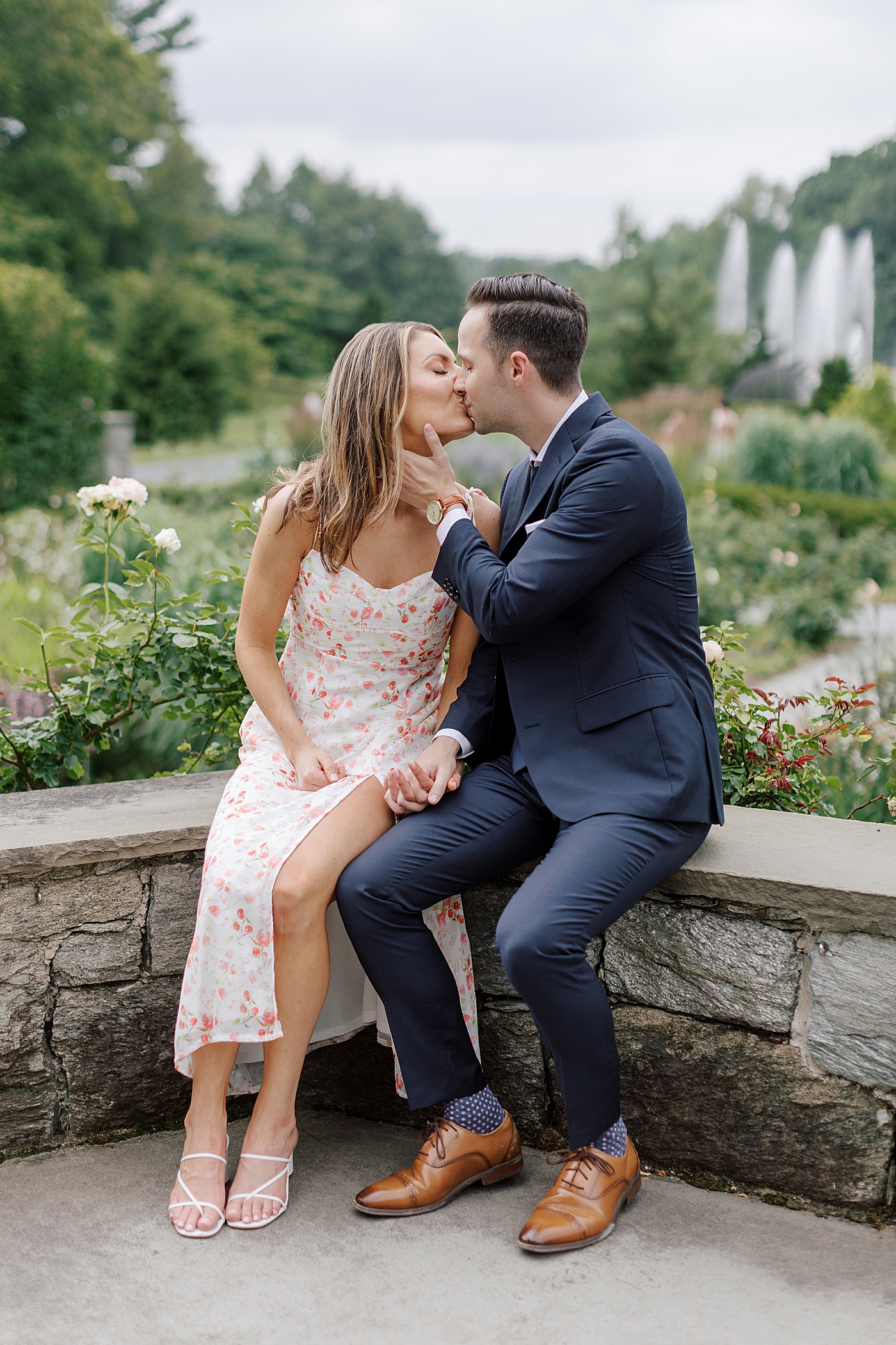 Couple kissing in a park sitting on a bench | Photo by Hope Helmuth Photography