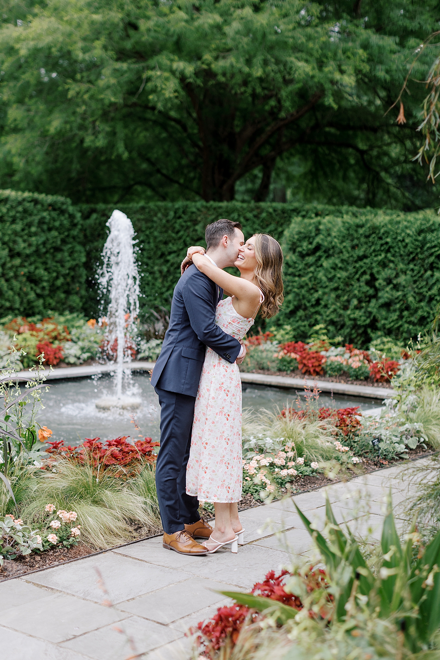 Couple embracing in a park | Engagement Session Guides | Photo by Hope Helmuth Photography