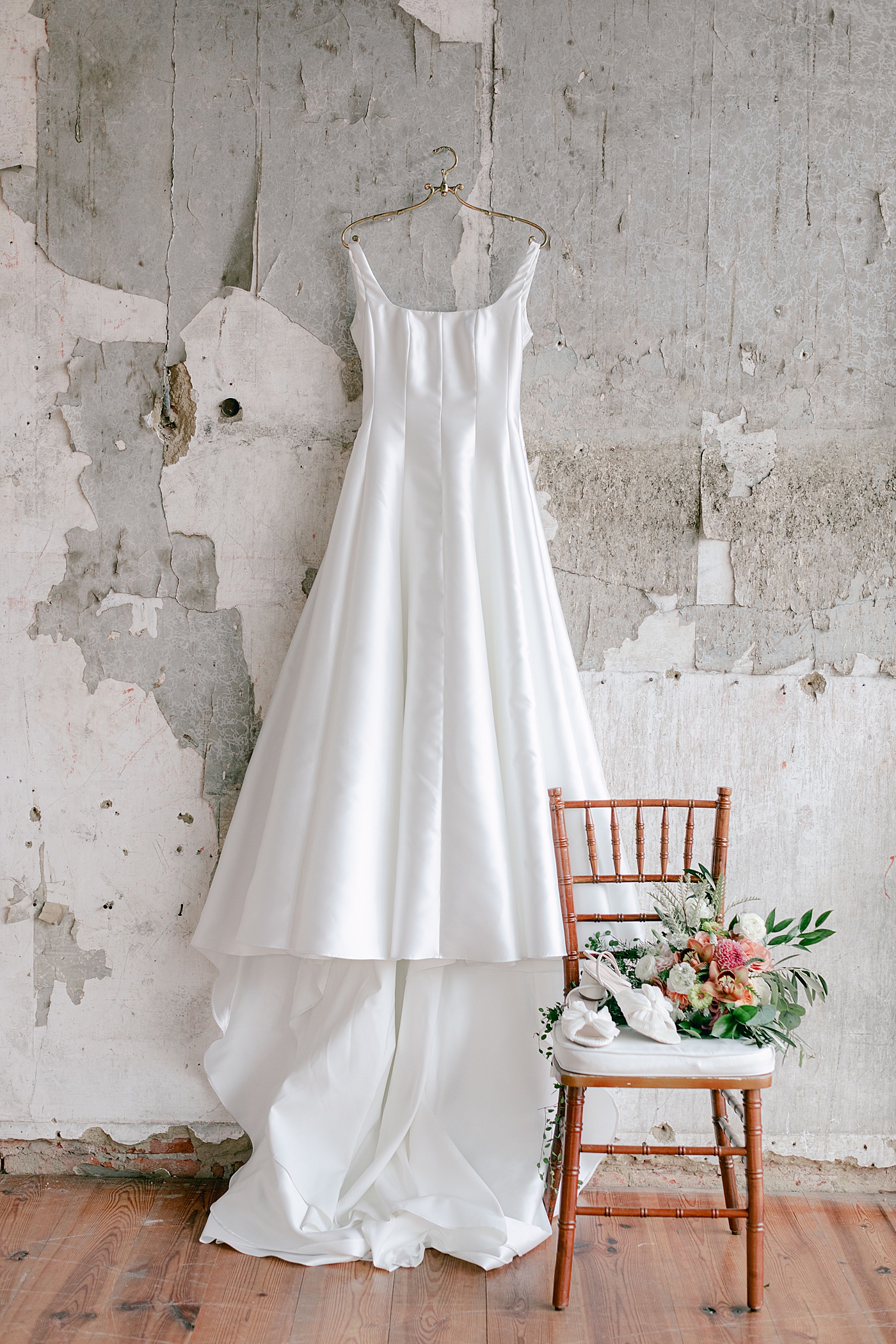 Bridal gown hanging from a gold hanger | Excelsior PA Wedding Photography by Hope Helmuth Photography