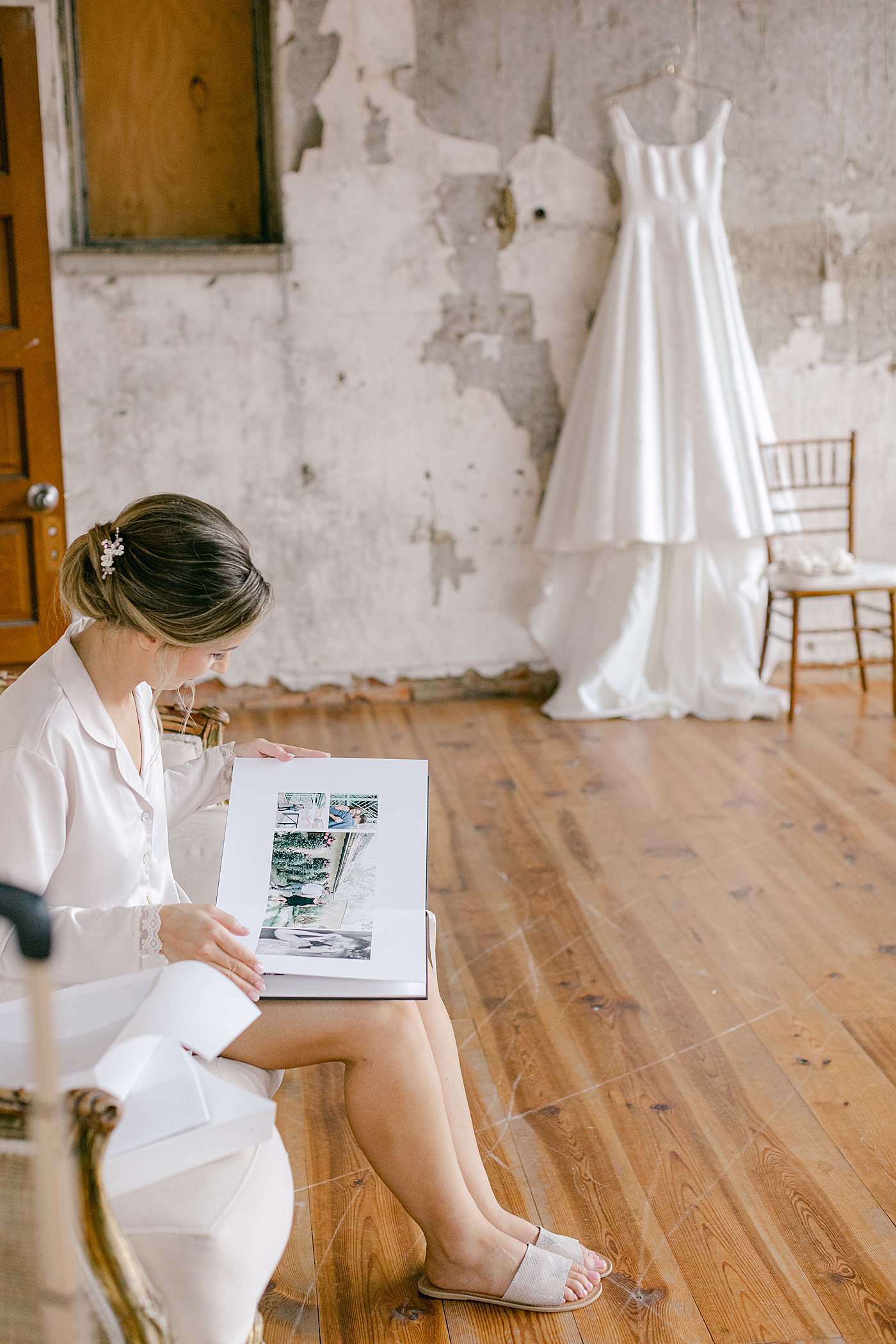 Bride looking through album gifted from groom | Excelsior PA Wedding Photography by Hope Helmuth Photography