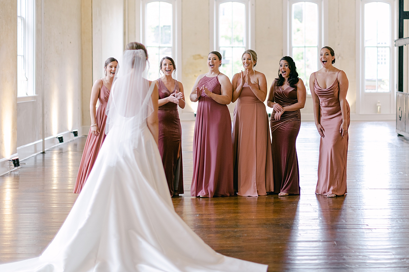 Bridesmaids seeing bride for the first time | Photo by Hope Helmuth Photography