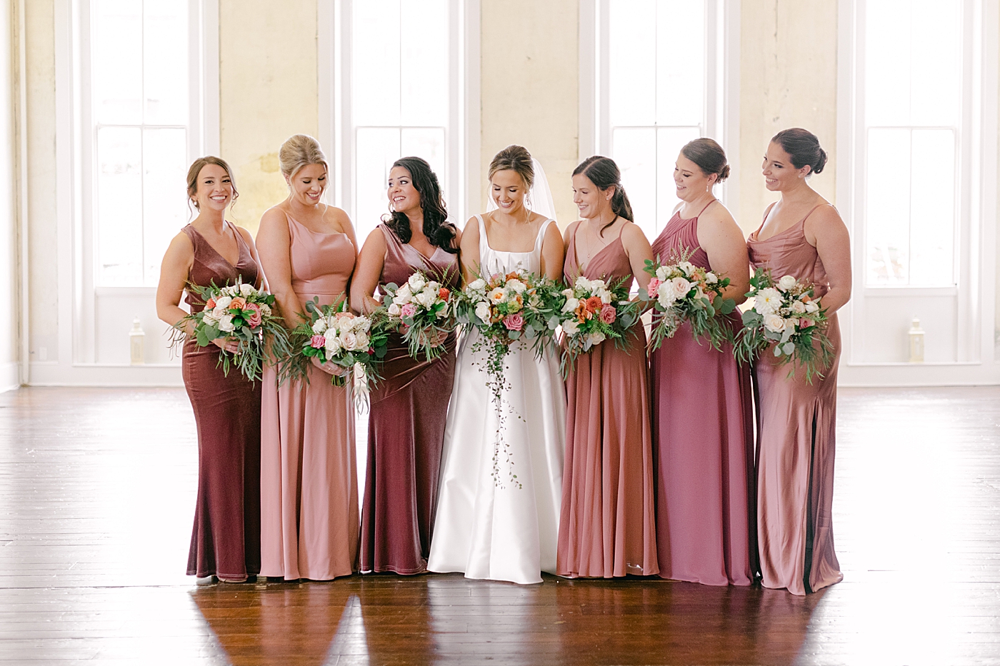 Bride with her bridesmaids and their flowers | Photo by Hope Helmuth Photography