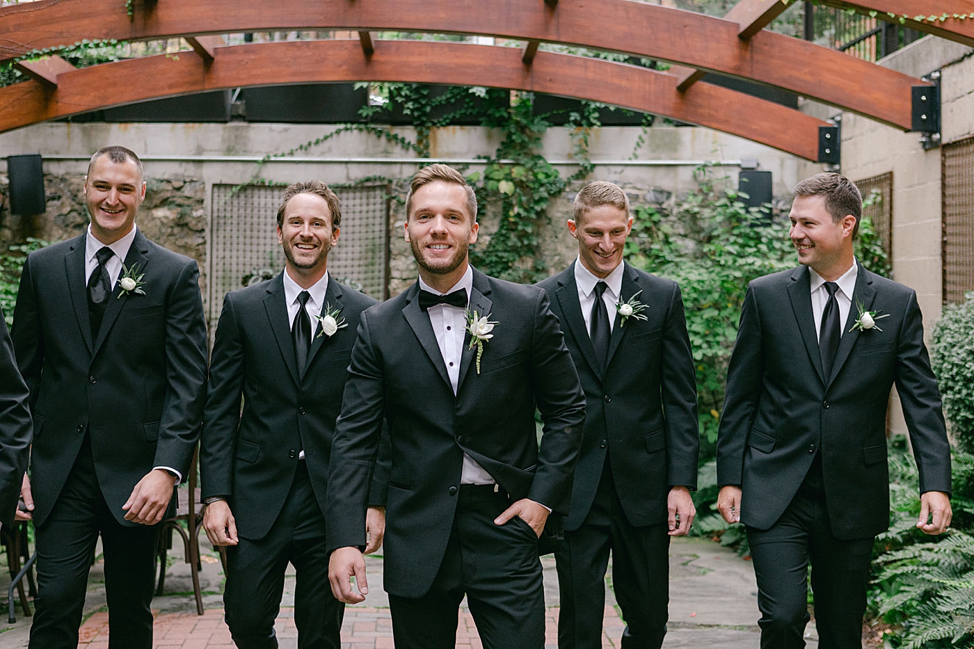 Groom having fun with groomsmen | Photo by Hope Helmuth Photography