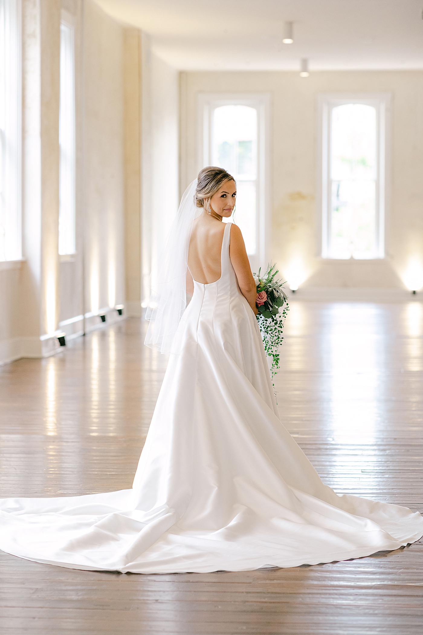 Portrait of bride in a room with big windows | Photo by Hope Helmuth Photography