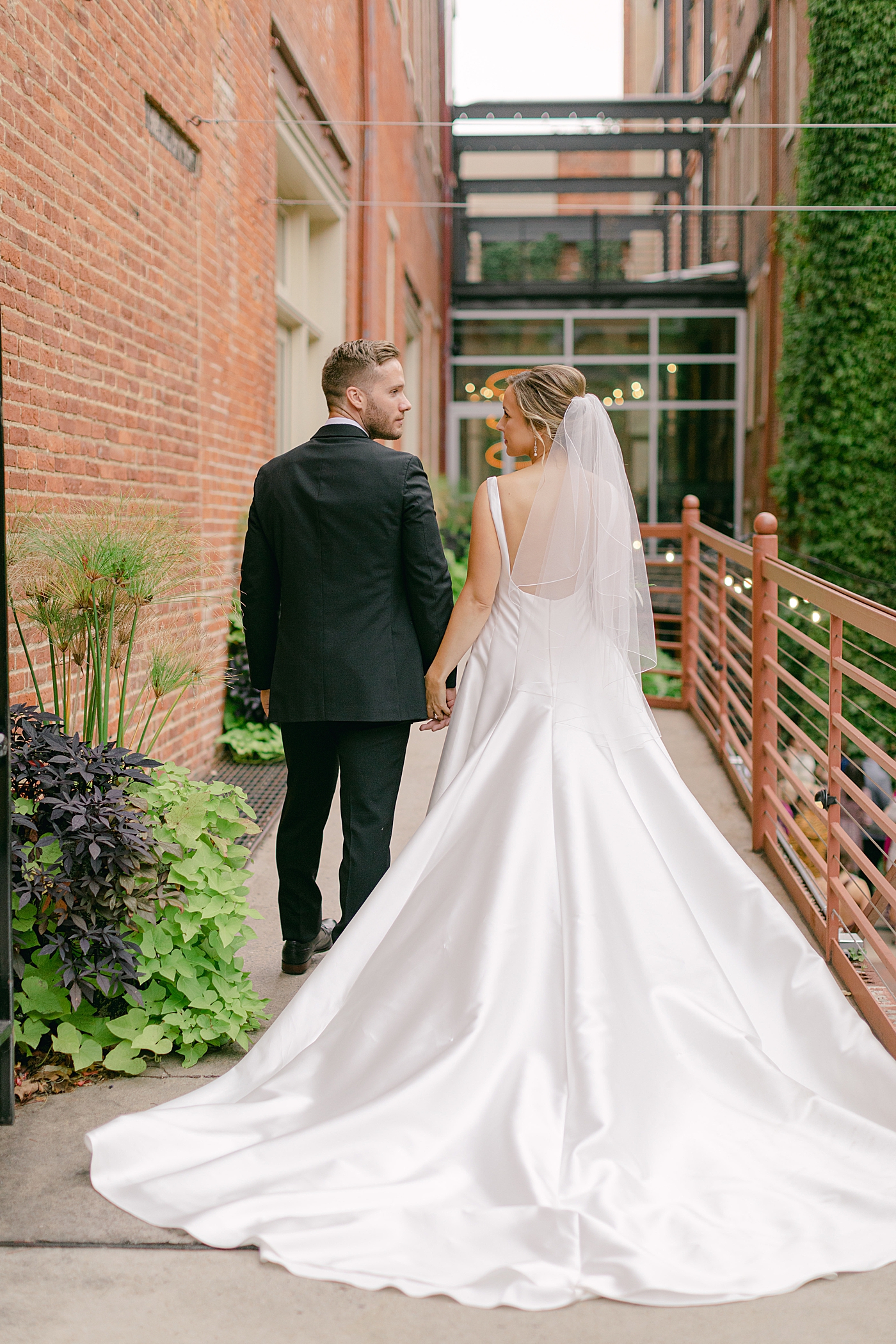 Bride and groom walking hand in hand | Photo by Hope Helmuth Photography