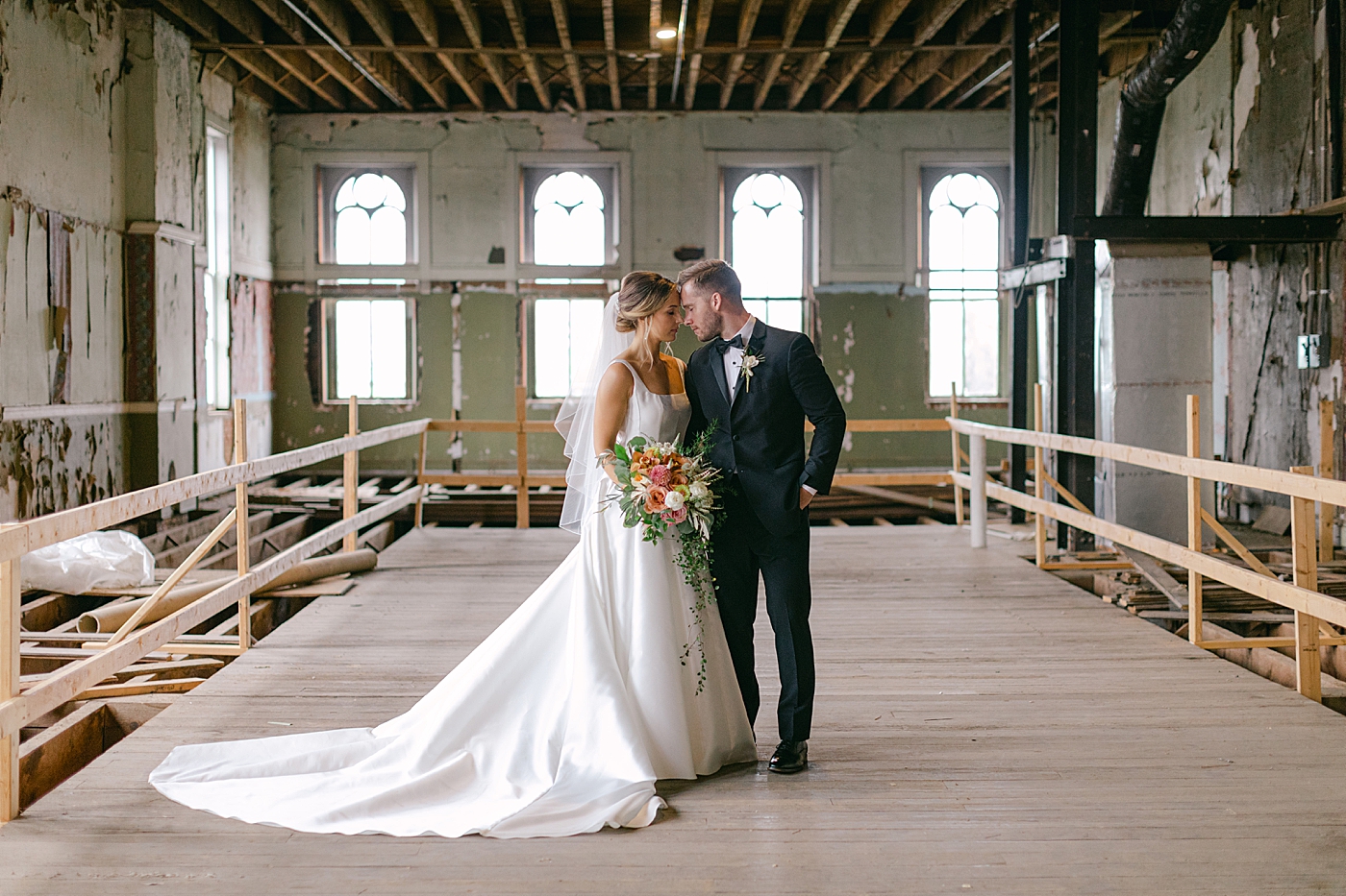Bride and groom with their foreheads together in an industrial building | Excelsior PA Wedding Photography by Hope Helmuth Photography