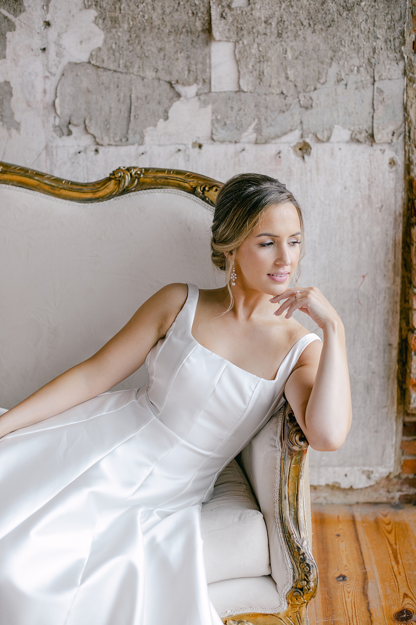 Bride sitting on a chaise lounge in a wedding dress | Excelsior PA Wedding Photography by Hope Helmuth Photography