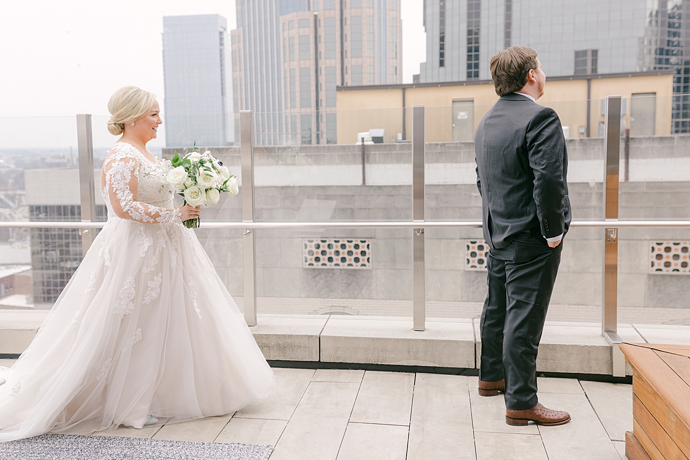 Bride and groom first look on a rooftop in Nashville | Photo by Hope Helmuth Photography