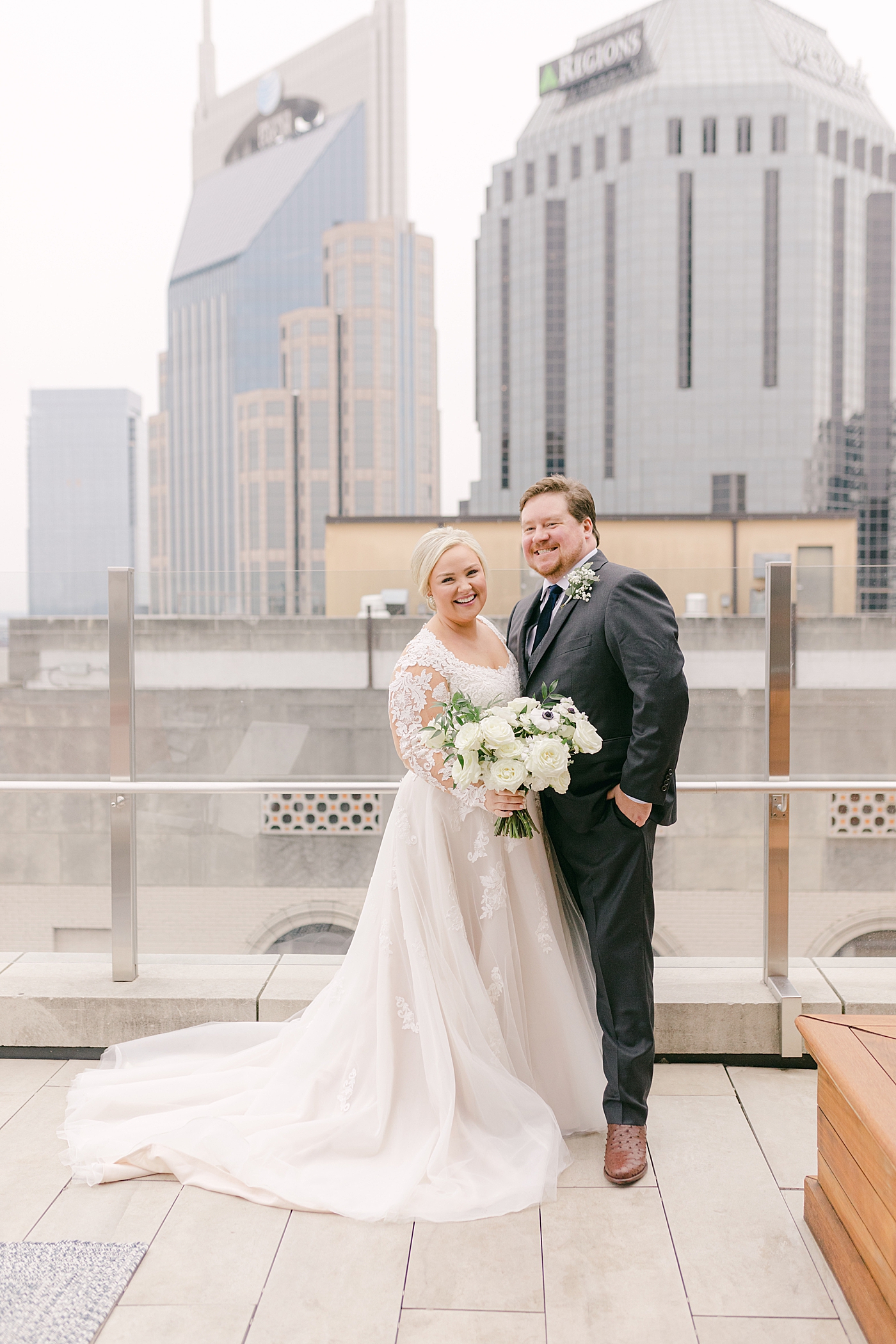 Bride and groom smiling on a rooftop in Nashville | Photo by Hope Helmuth Photography