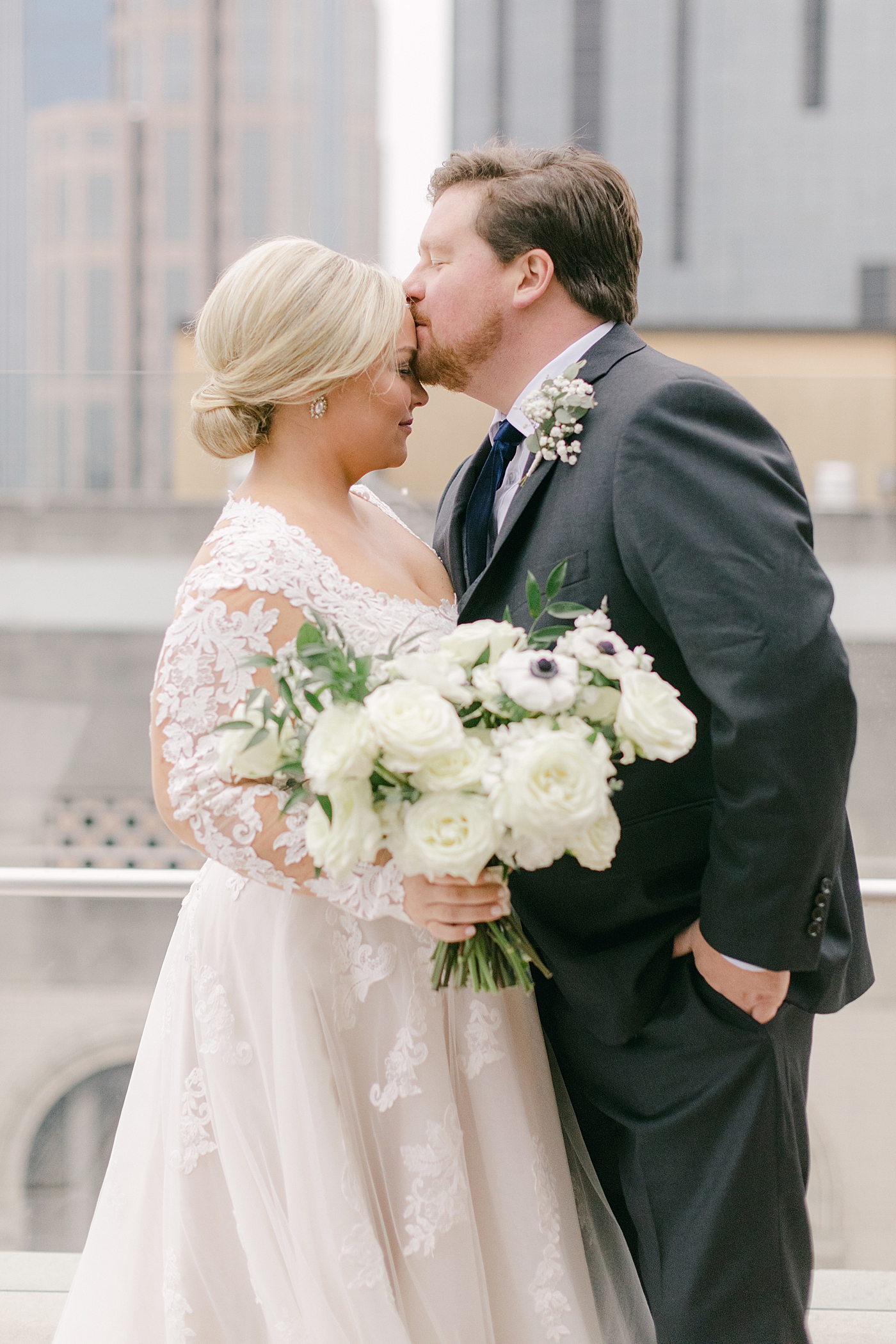 Bride and groom portraits on a rooftop | Photo by Hope Helmuth Photography