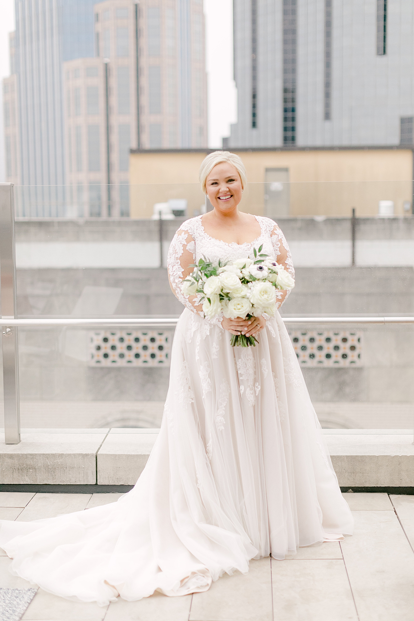 Bride with her bouquet on a rooftop during Noelle, Nashville Wedding | Photo by Hope Helmuth Photography