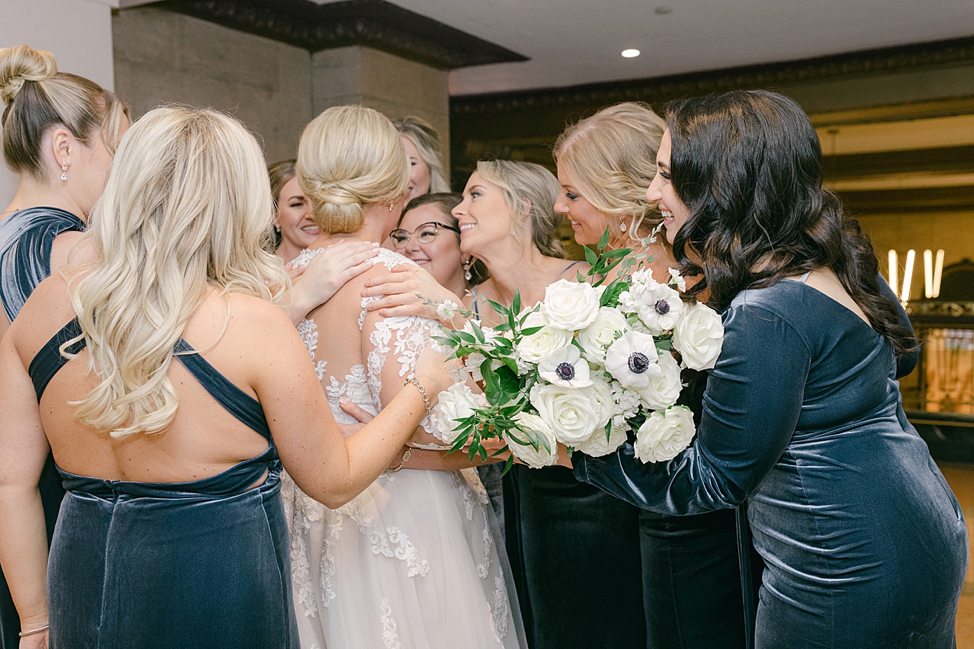 Bridesmaids hugging the bride during Noelle, Nashville Wedding | Photo by Hope Helmuth Photography