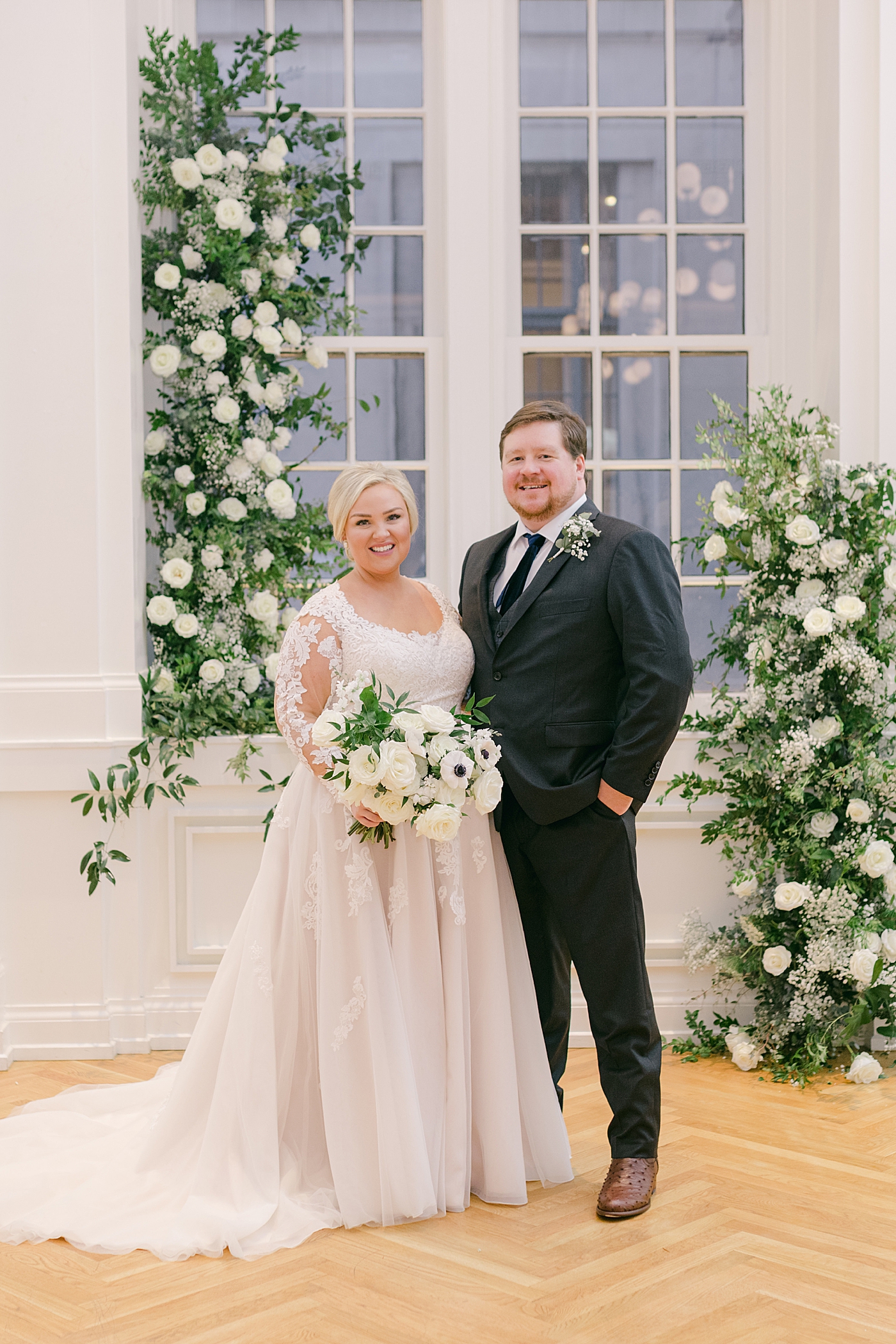 Bride and groom near floral installation during Noelle, Nashville Wedding | Photo by Hope Helmuth Photography