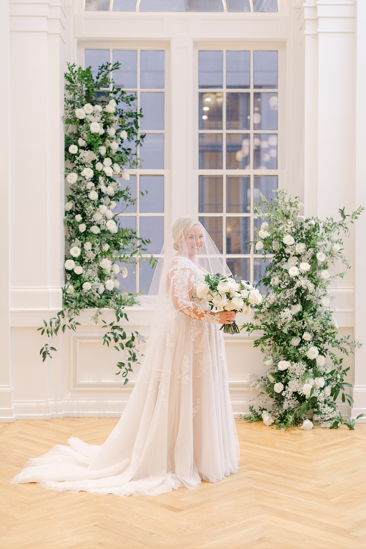 Bride near floral installation during Noelle, Nashville Wedding | Photo by Hope Helmuth Photography 