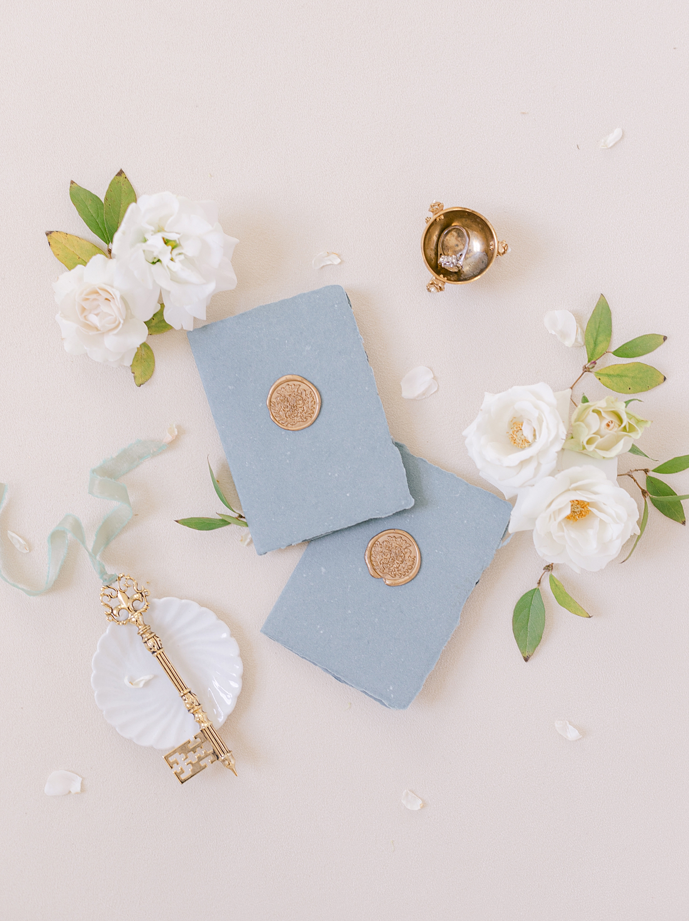 Blue vow books styled with florals | Photo by Hope Helmuth Photograpghy