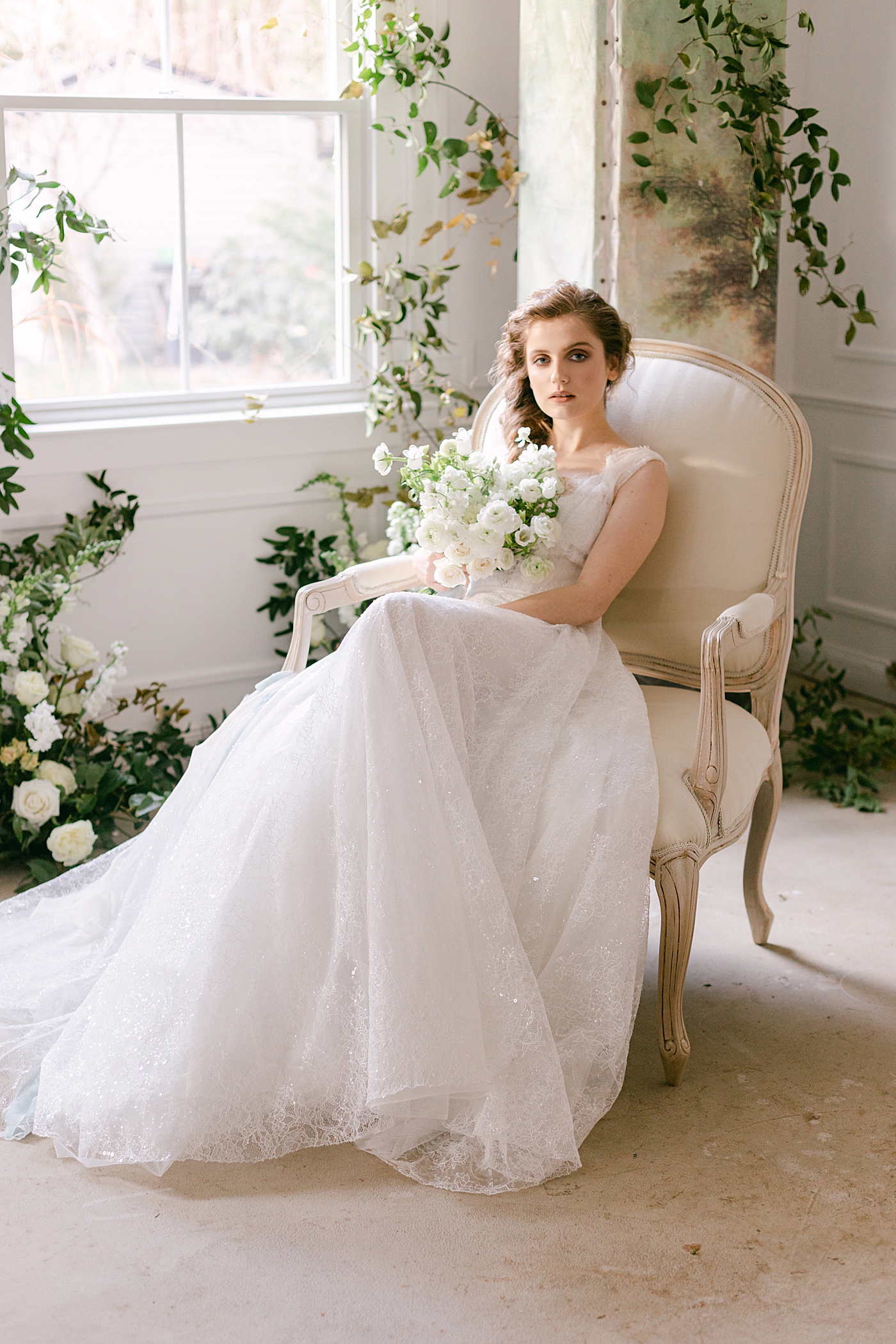 Bride sitting in a chair holding a bouquet during Old World Romance Editorial | Photo by Hope Helmuth Photograpghy