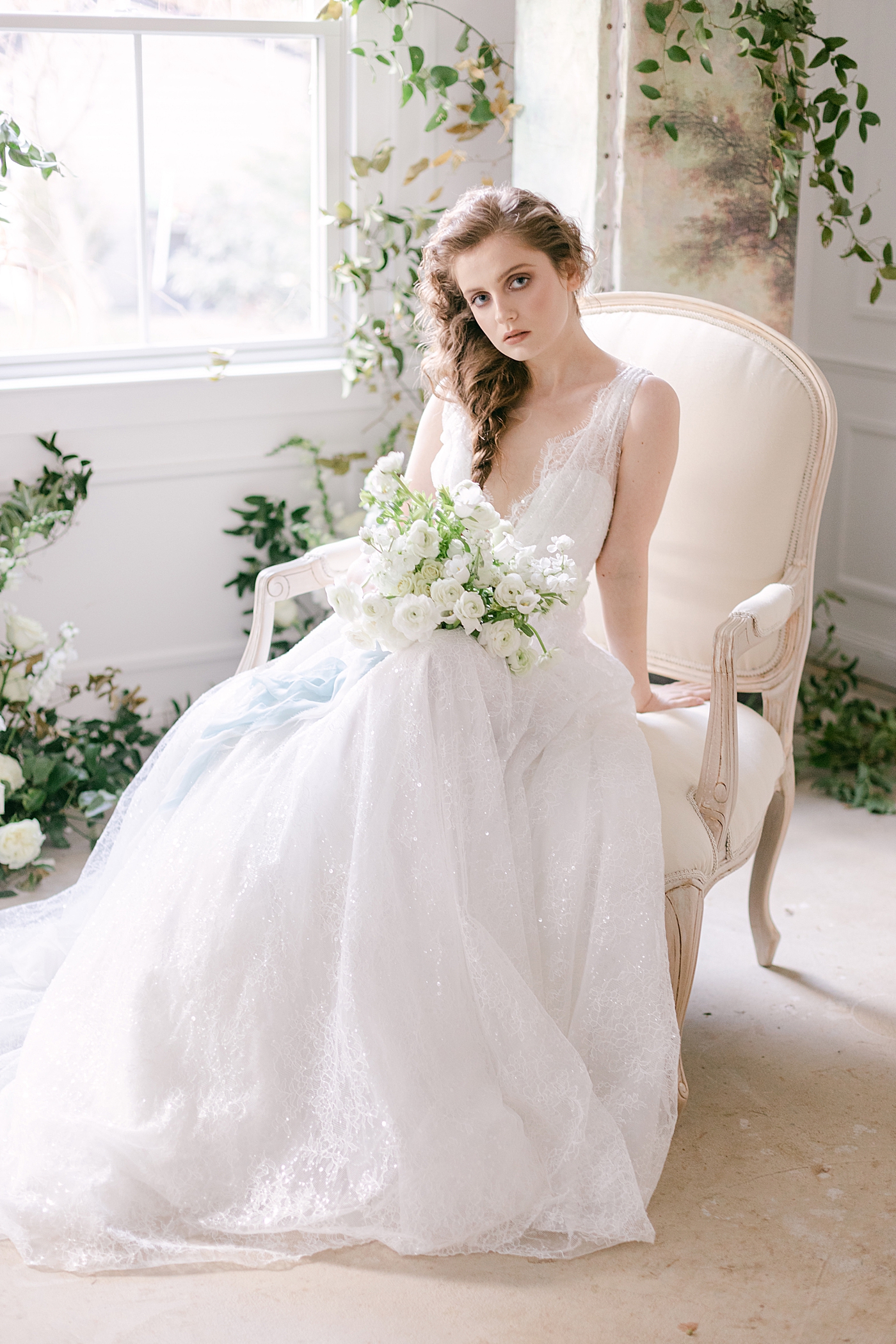 Bride in white gown sitting in a chair | Photo by Hope Helmuth Photograpghy