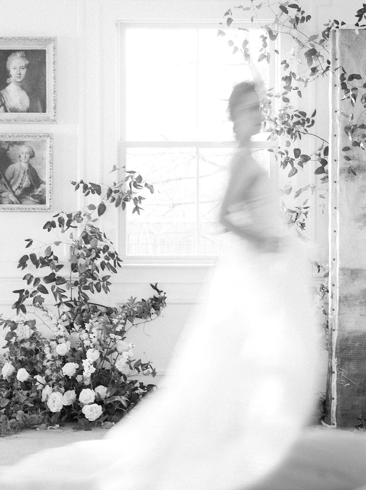 Blurred black and white image of a bride in front of a window | Photo by Hope Helmuth Photograpghy