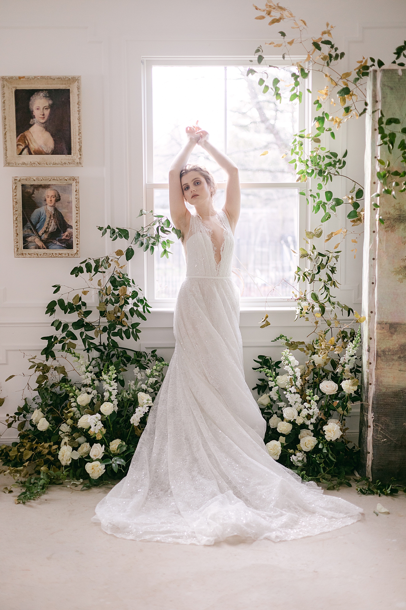 Bride standing near a window styled with florals | Photo by Hope Helmuth Photograpghy