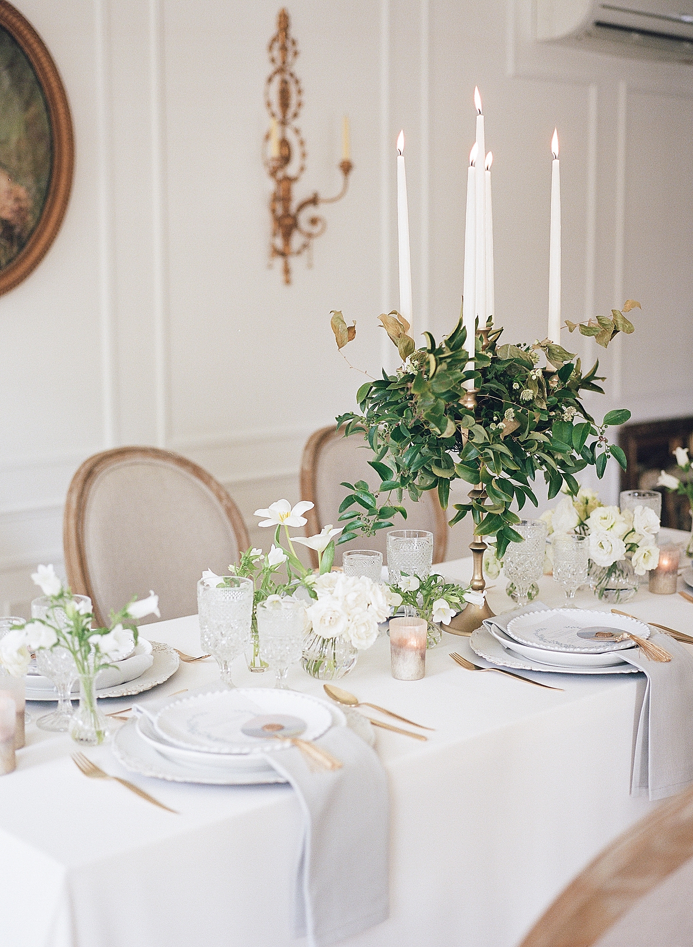 Table with pillar candles and greenery | Photo by Hope Helmuth Photograpghy