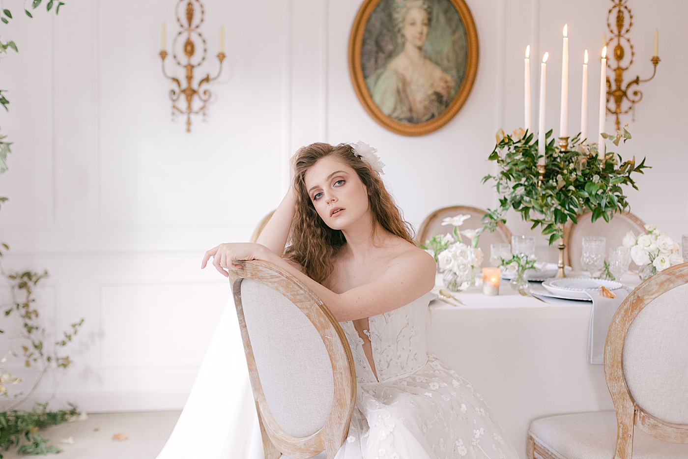 Woman with wavy hair and wedding gown sitting in a chair | Photo by Hope Helmuth Photograpghy