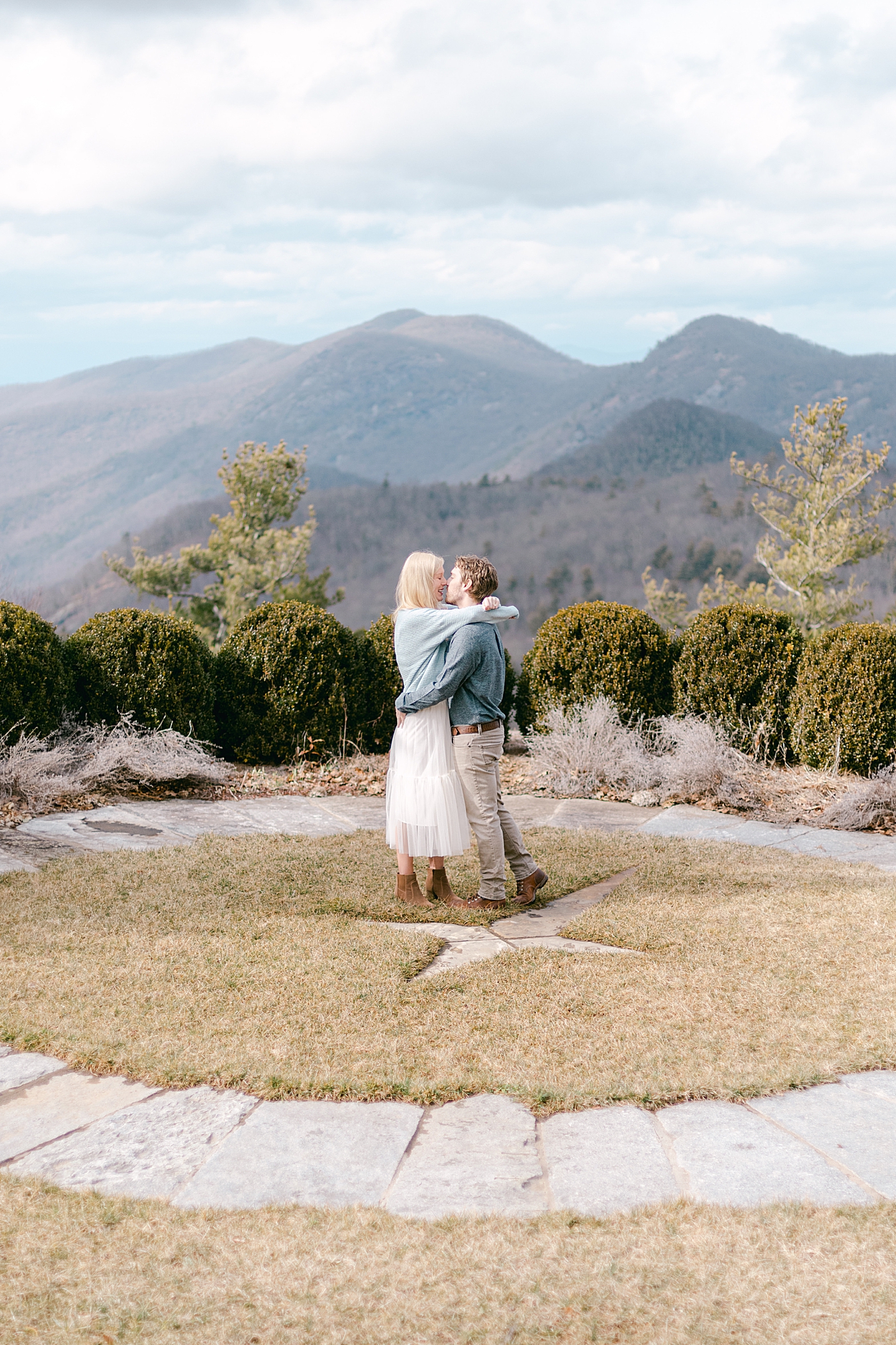 Couple kissing in the mountains during their Highlands Engagement Session | Image by Hope Helmuth Photography