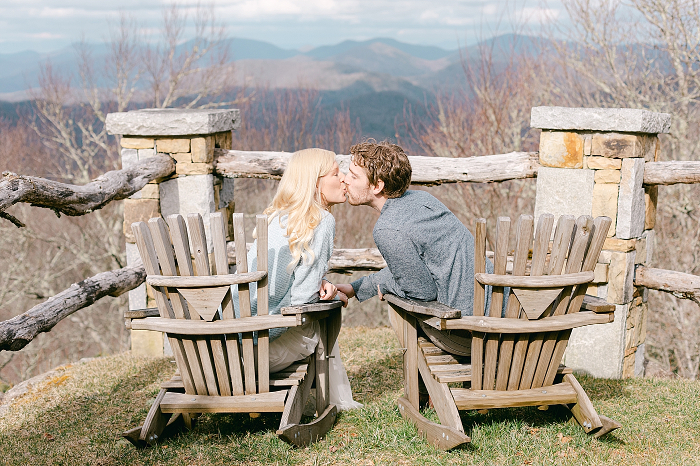 Couple sitting in chairs kissing | Image by Hope Helmuth Photography