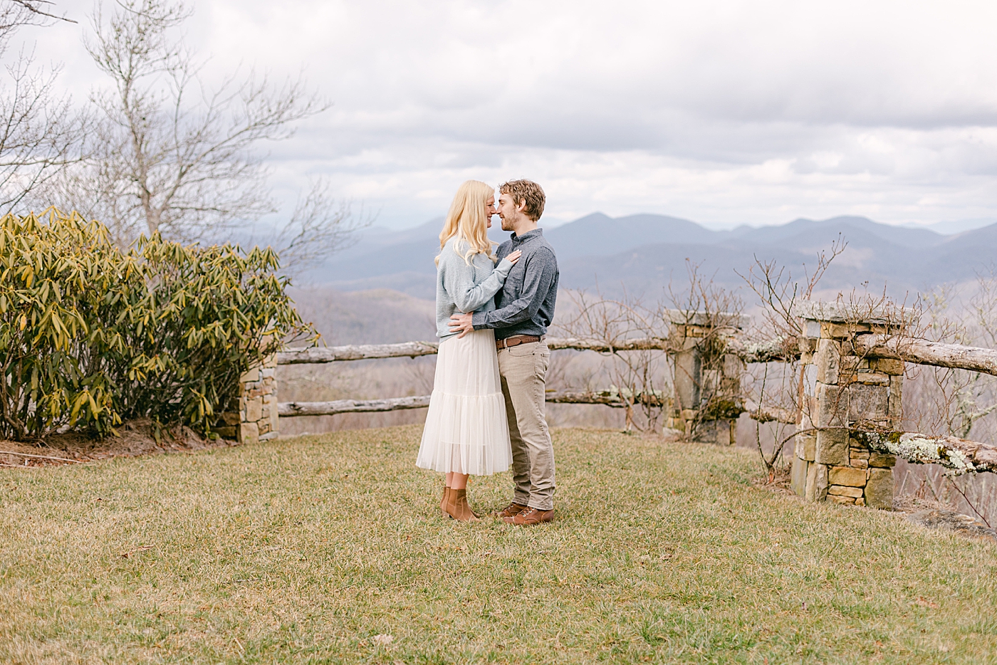 Couple standing nose to nose in the mountains | Image by Hope Helmuth Photography