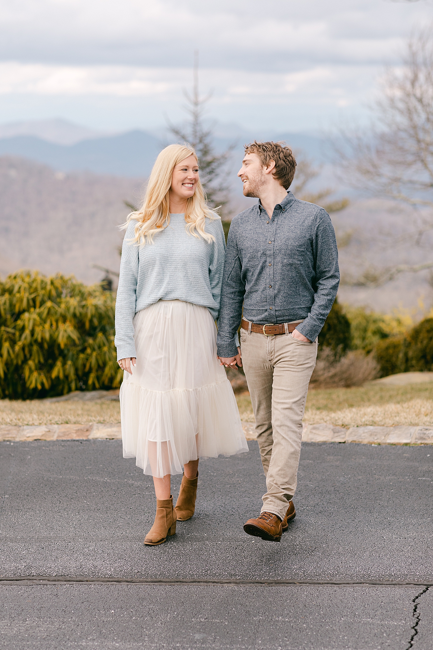 Couple holding hands walking during their Highlands Engagement Session | Image by Hope Helmuth Photography