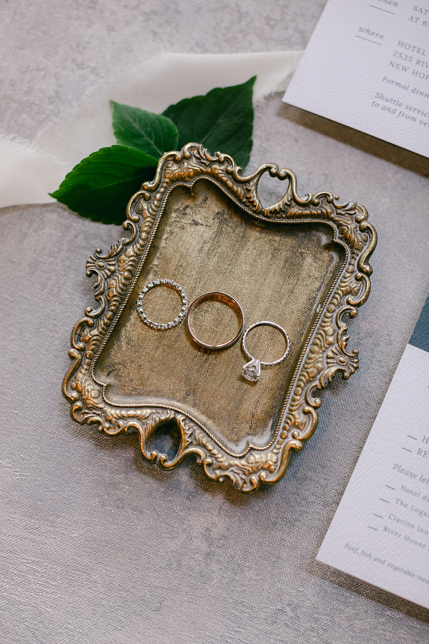 Wedding rings on a brass dish during Hotel du Village Wedding | Image by Hope Helmuth Photography