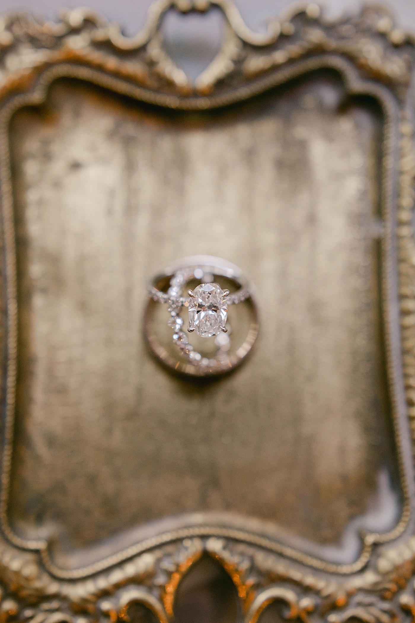 Wedding rings styled on a brass platter during Hotel du Village Wedding | Image by Hope Helmuth Photography