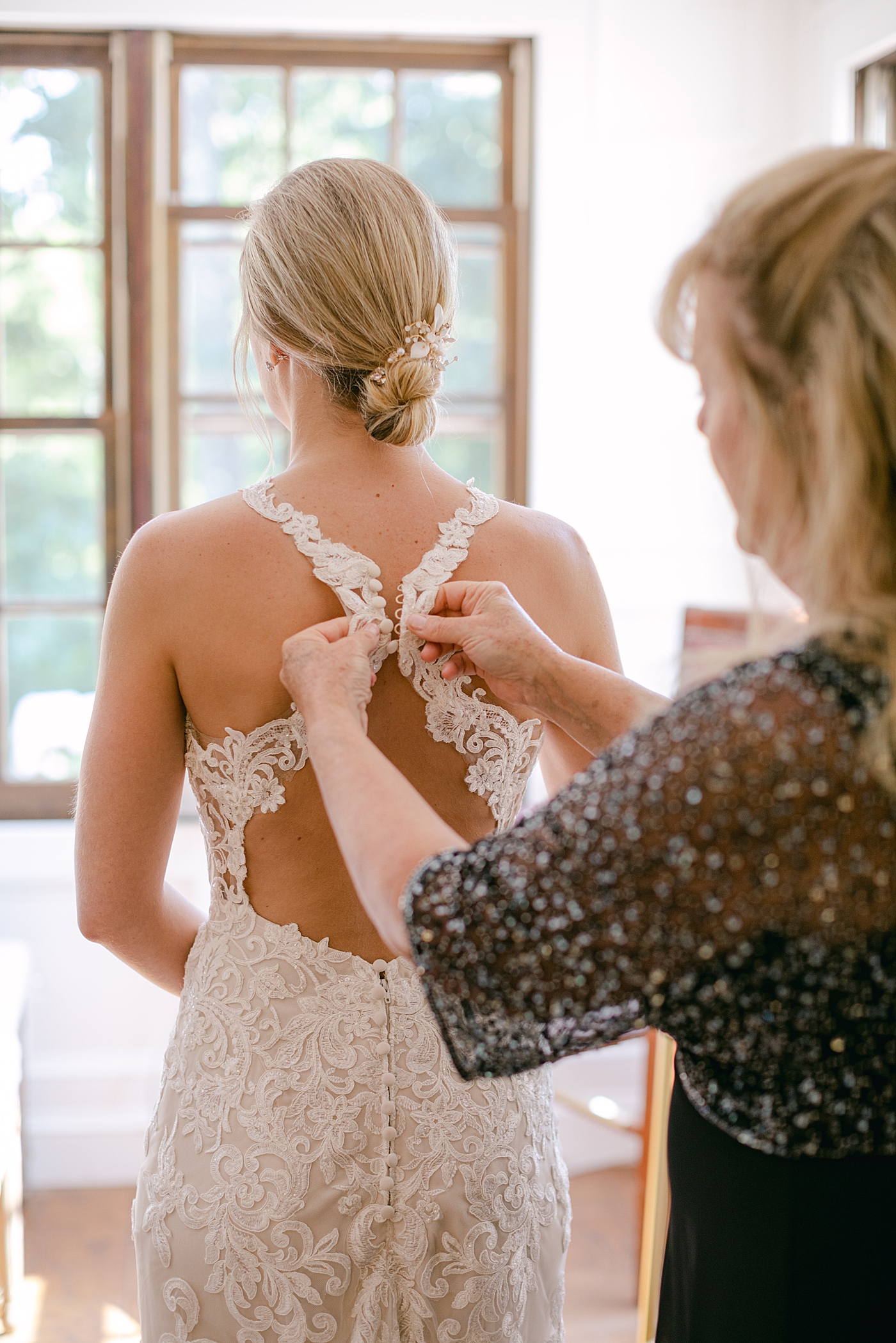 Bride getting into her dress | Image by Hope Helmuth Photography